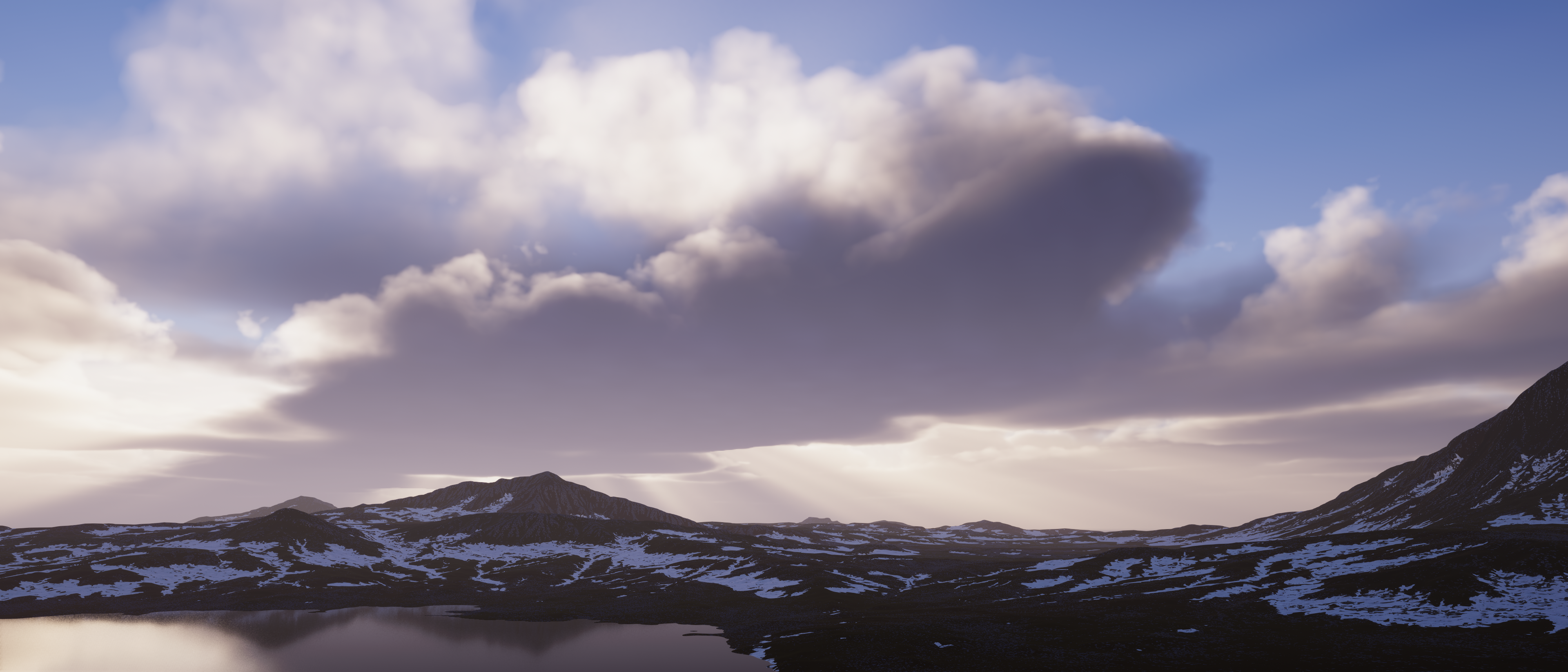 image of cloudy overcast on mountainous terrain with a lake on the bottom left
