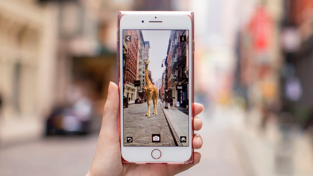 View of a phone screen with a giraffe in AR in an urban setting.