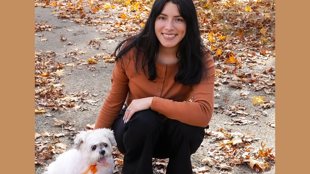 Esther kneeling down in the leaves with her dog Tracy