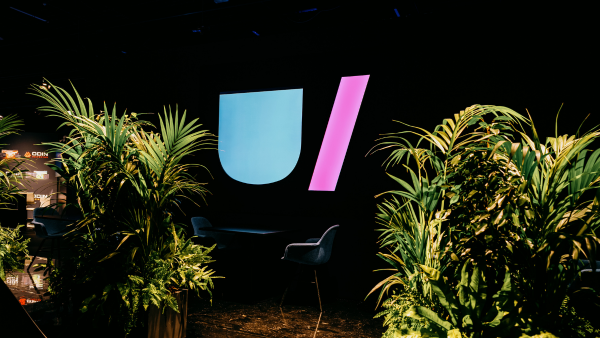 Mounted Unite 2023 logo between two ferns within the Taets Art and Event Park in Amsterdam