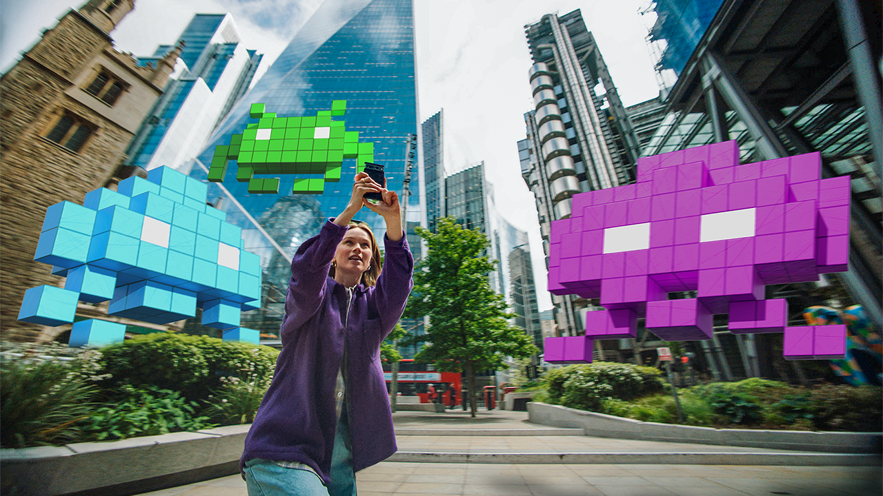 Adult woman plays SPACE INVADERS: World Defense on a city street (Image courtesy of Google)