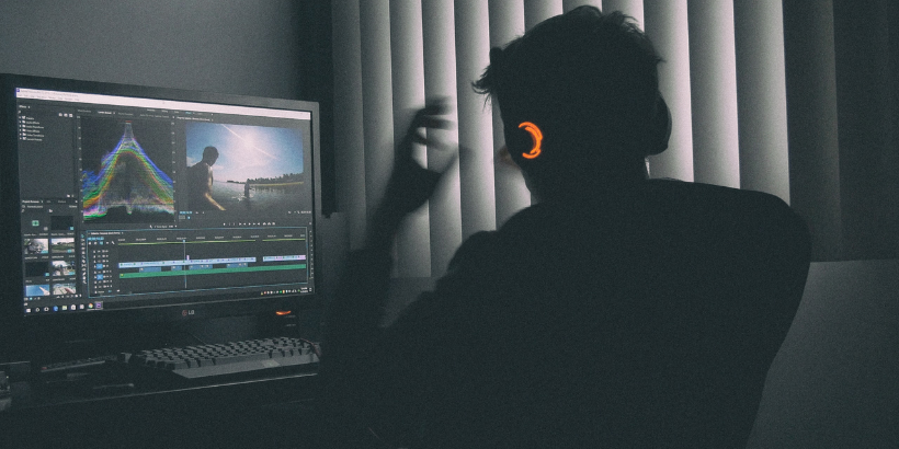 Unity stock image of developer at work with light-up headphones