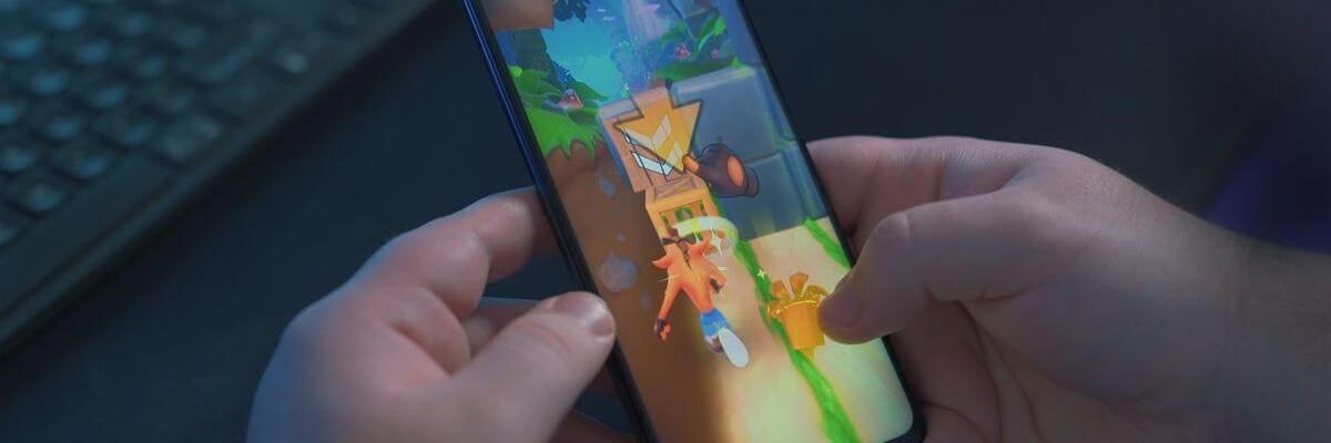 Image of hands holding a smartphone while playing a mobile game | Hero image for "Looking to boost your game’s LTV? Try an on-device advertising campaign"
