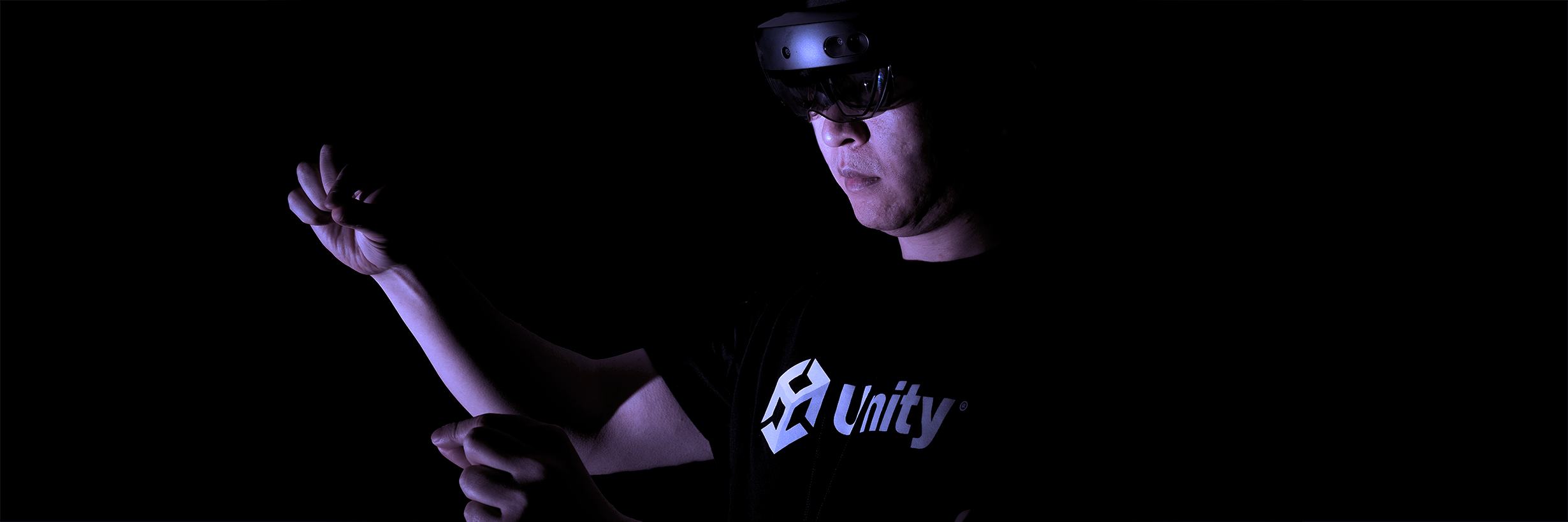 Unity Industry UX Designer Desmond Gao testing a build on HoloLens 2